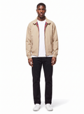 Beige harrington jacket with plaid lining worn by model, front view