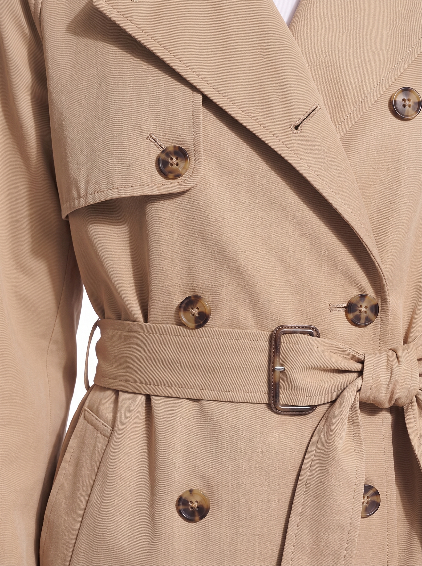 Trench coat buttons and belt close up detail