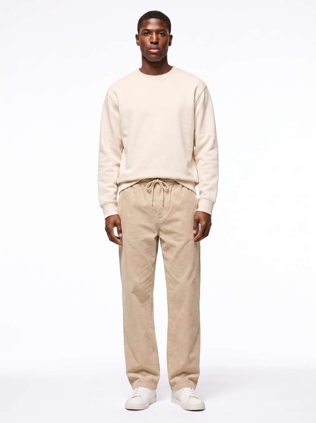Beige wide leg corduroy pants worn by model, front view