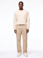 Beige wide leg corduroy pants worn by model, front view