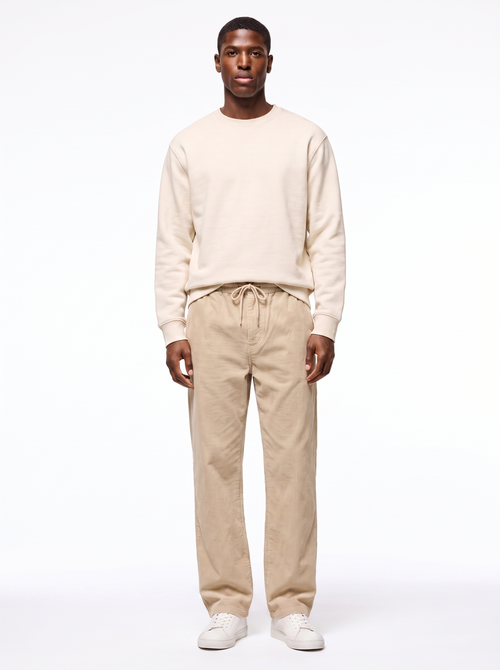 Beige wide leg corduroy pants worn by model, front view