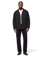 Black canvas chore jacket worn by model, front view