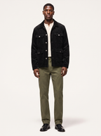 Black corduroy cargo jacket with flap pockets, front view on model