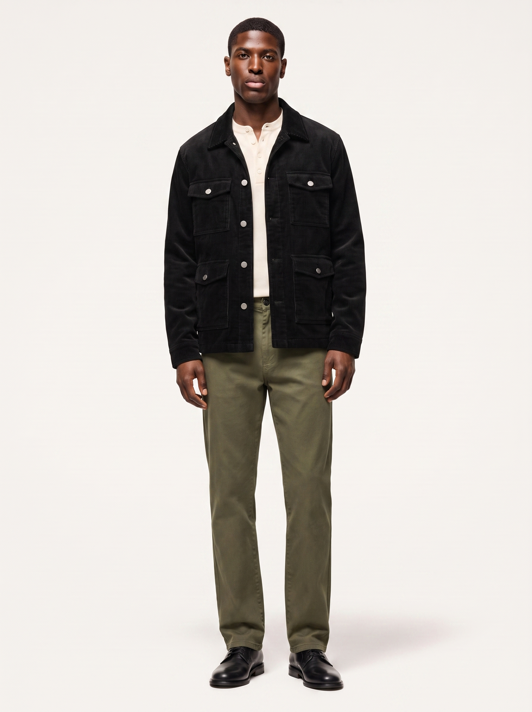 Black corduroy cargo jacket with flap pockets, front view on model