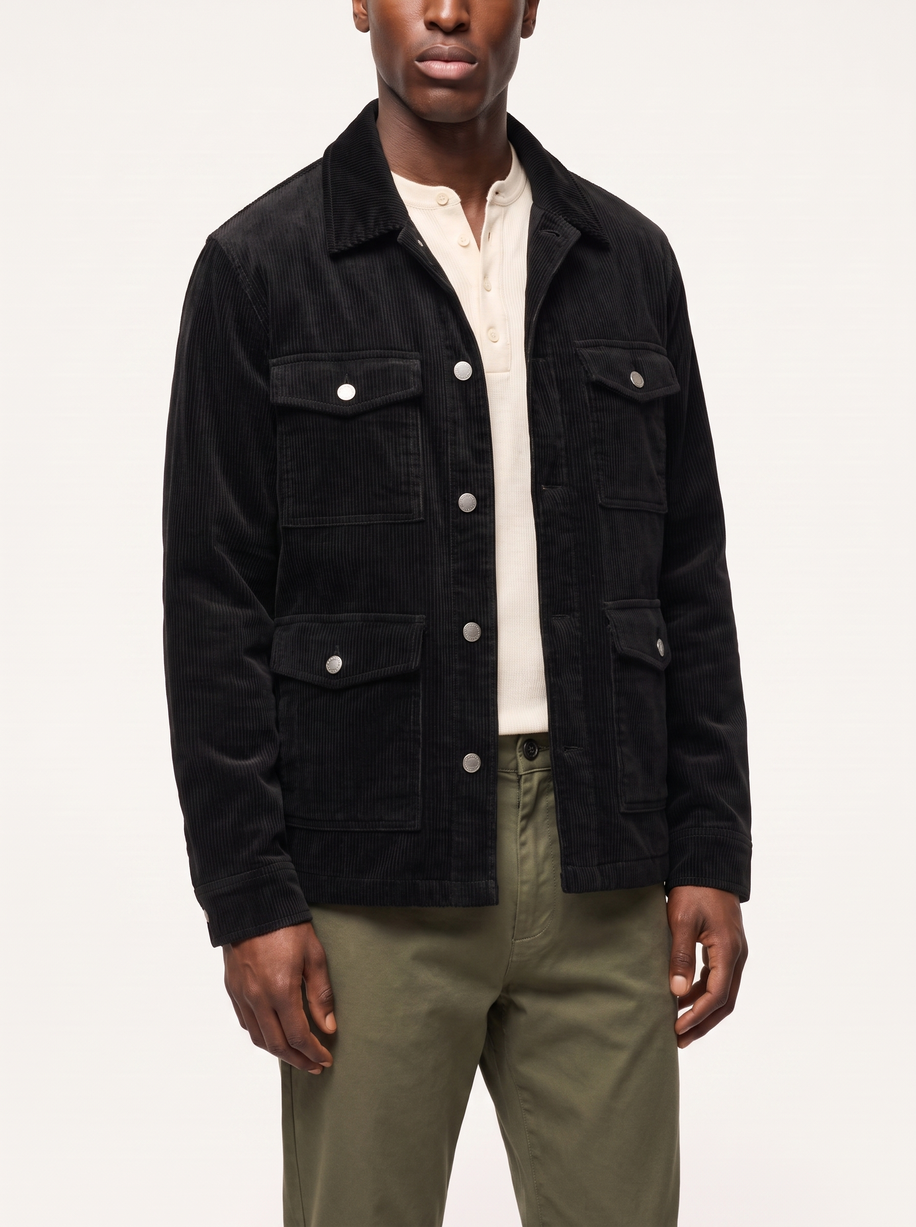 Black corduroy cargo jacket three quarter view showing relaxed fit