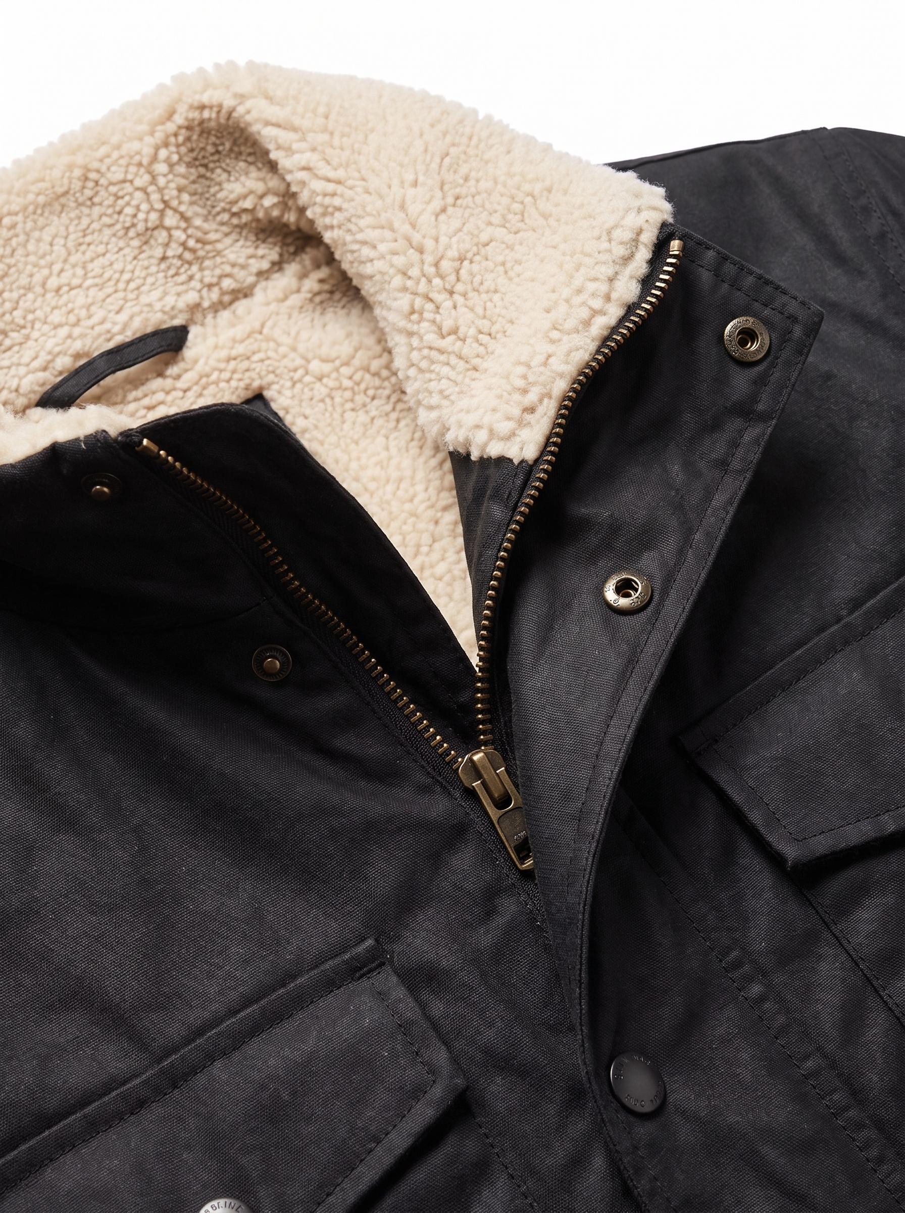 Close up of sherpa collar, zip and waxed canvas texture