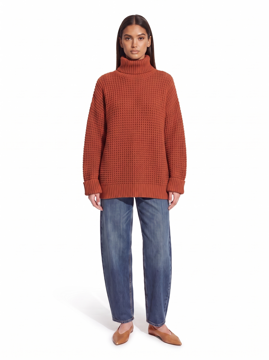 Brick red oversized honeycomb knit turtleneck sweater worn by model, front view on white