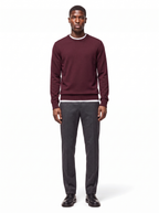 Deep burgundy crew neck sweater worn by model, front view