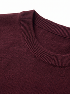 Close up of ribbed collar and knit on burgundy sweater