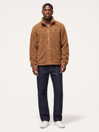 Camel brown sherpa fleece zip jacket worn by model, front view on white