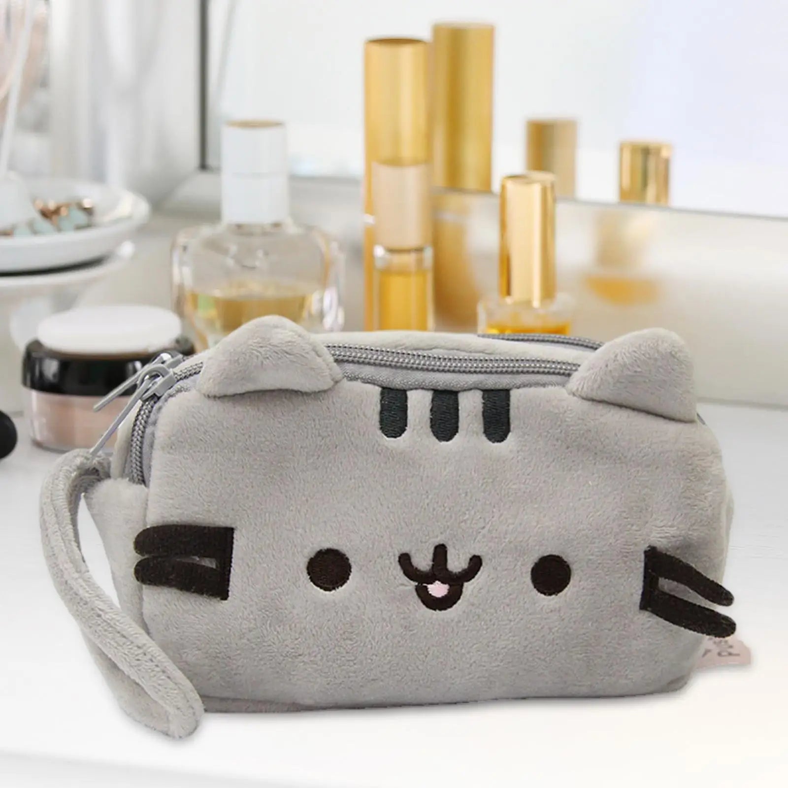 Cat plush pencil case shown open with stationery inside