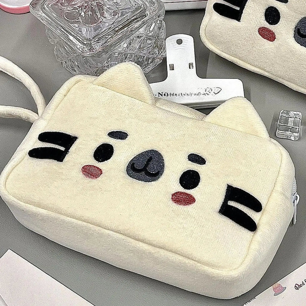 Cat plush pencil case held in hand for scale
