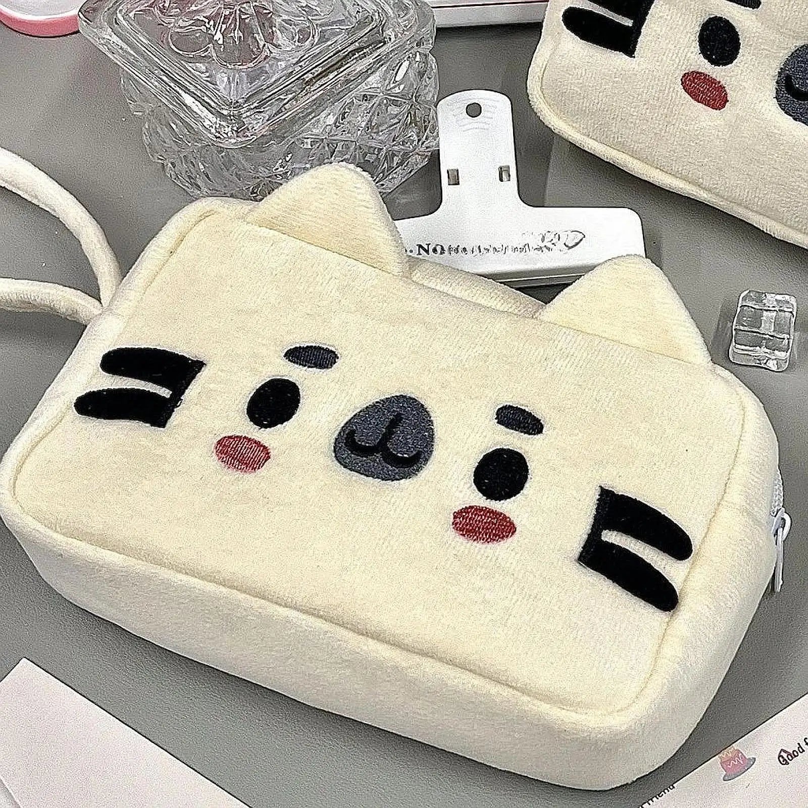 Cat plush pencil case held in hand for scale