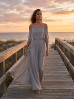 Grey chiffon cold-shoulder top and flared bottom two-piece set worn on a boardwalk