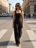 Black cotton-linen square neck suspender maxi dress worn on a city street