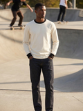 Cream long sleeve cotton ringer tee with black trim worn at a skate park