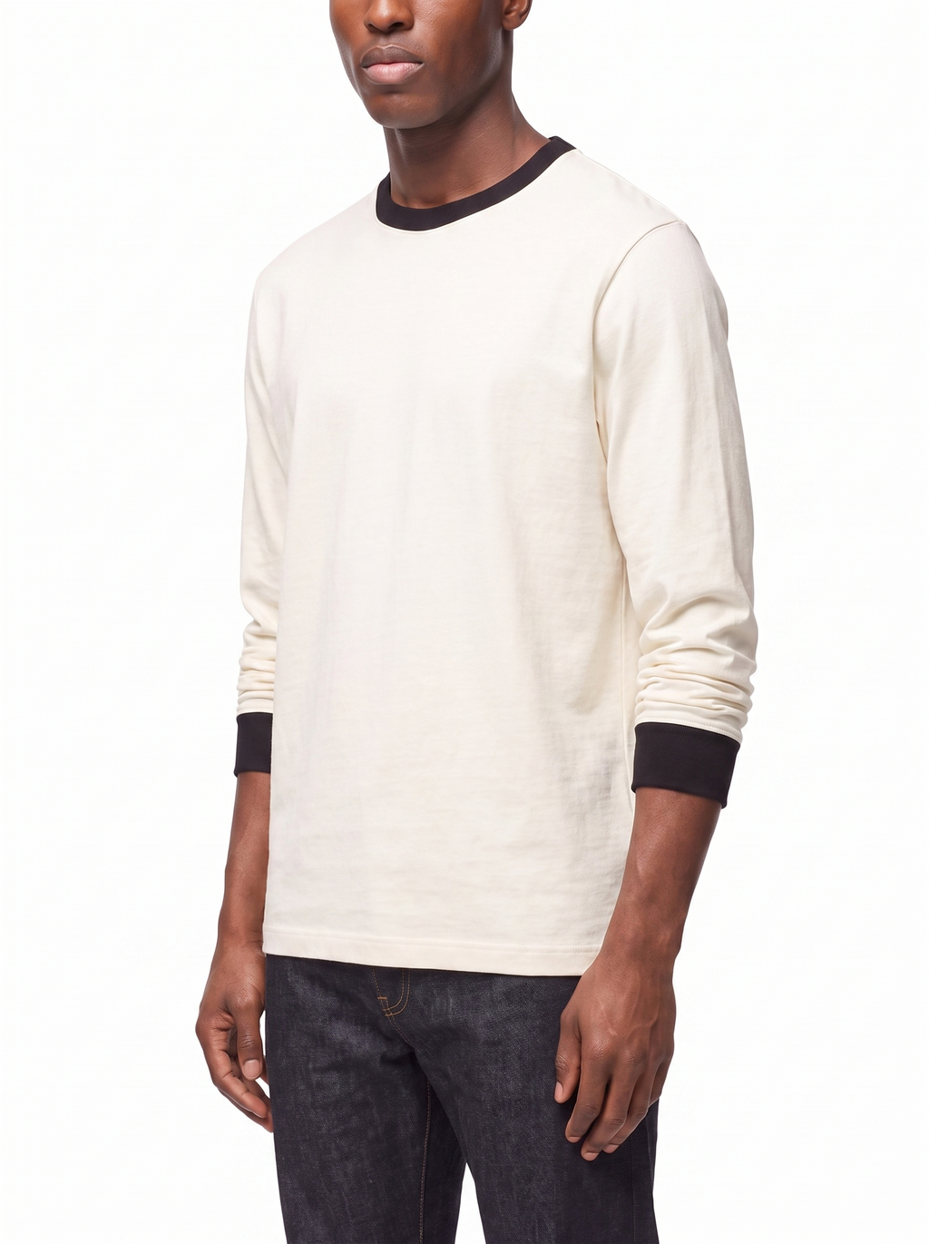 Three quarter view showing boxy fit of cream ringer tee