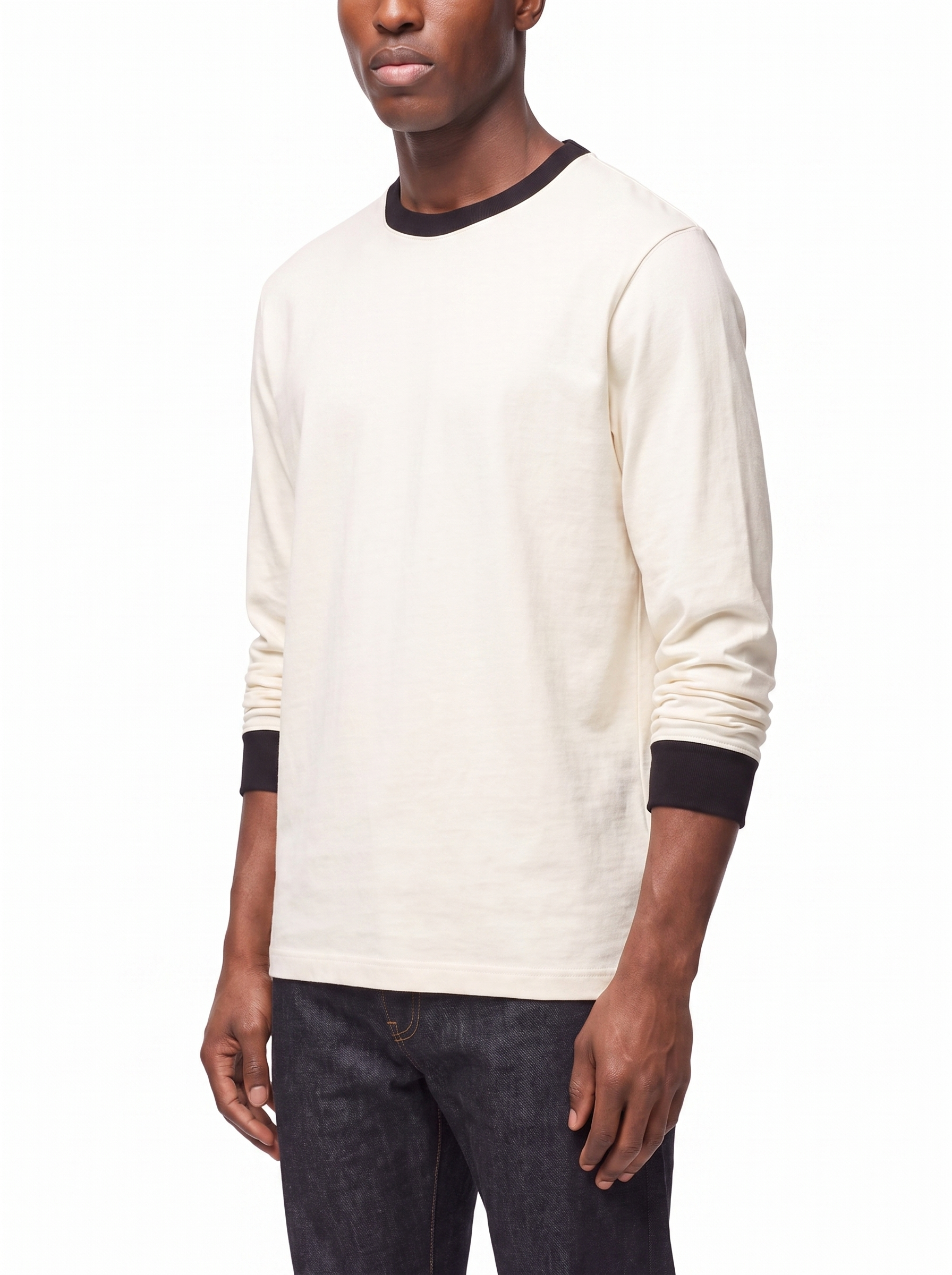 Three quarter view showing boxy fit of cream ringer tee