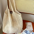 Crochet mesh tote bag held by the straps