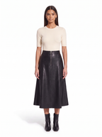Black faux leather flared midi skirt worn by model, front view