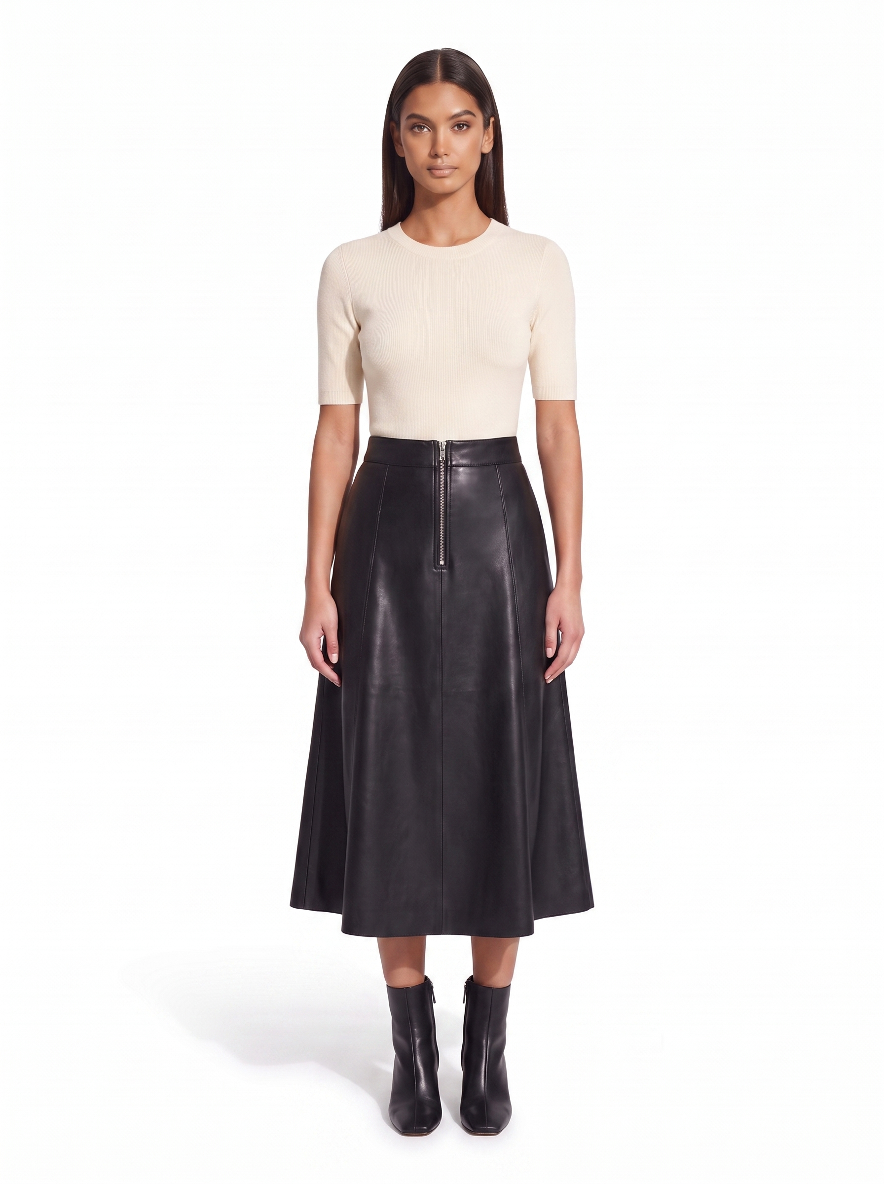 Black faux leather flared midi skirt worn by model, front view