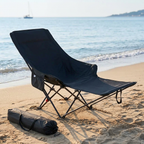 Foldable beach chair set up on golden sand by the shoreline