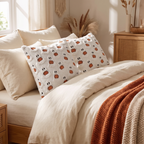 Ghost and pumpkin pillows propped on a cozy bed