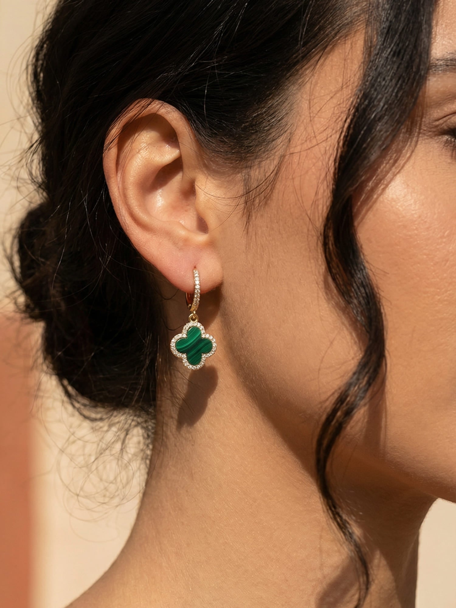 Gold-tone clover earrings, styled view