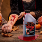 Fake blood bottle beside an arm showing applied wound effects