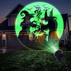 Projector casting green witch and bat patterns across a house at night