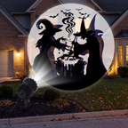 Projector staked in a front yard casting patterns onto a house at night
