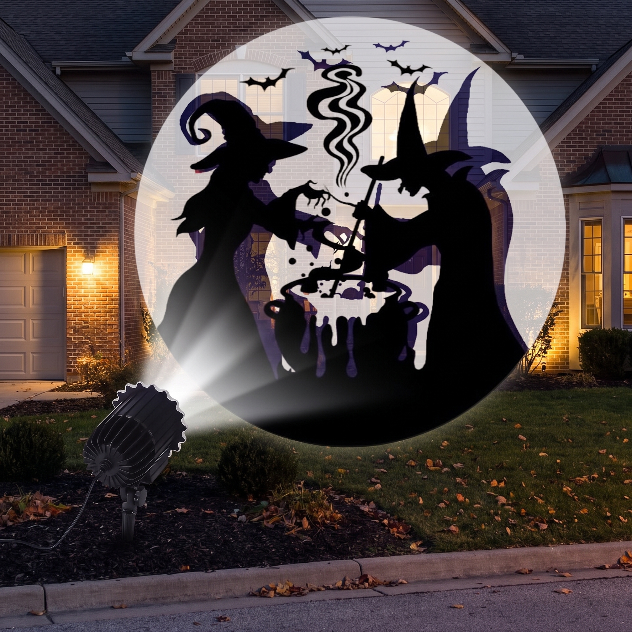 Projector staked in a front yard casting patterns onto a house at night