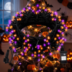 Close-up of purple and orange LED bulbs on the strand