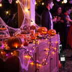 String lights framing a mantel decorated for Halloween