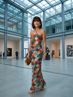 Woman wearing the scale-pattern print fitted halter maxi dress in a museum atrium