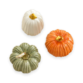 Handcrafted ceramic pumpkin decoration on a white background