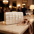 Acrylic evening clutch purse with lock closure on a marble console table