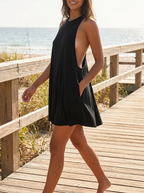 Black backless loose T-shirt swing mini dress on a seaside boardwalk