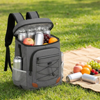 Grey insulated 32-can backpack cooler bag on a park lawn