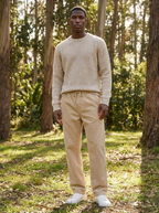 Beige wide leg corduroy pants with drawstring waist worn in a sunlit park