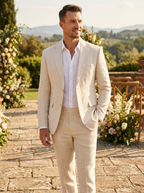 Man wearing a cream linen two-piece suit with notch lapels on a wedding terrace