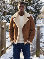 Brown suede-look aviator jacket with cream fleece collar on a winter street
