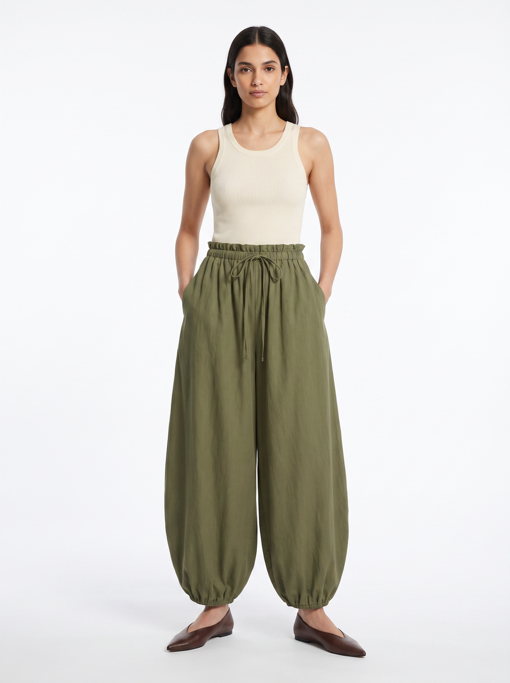 High-waisted balloon pants in olive, worn by model