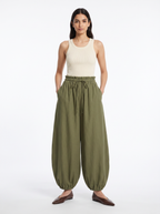 High-waisted balloon pants in olive, worn by model