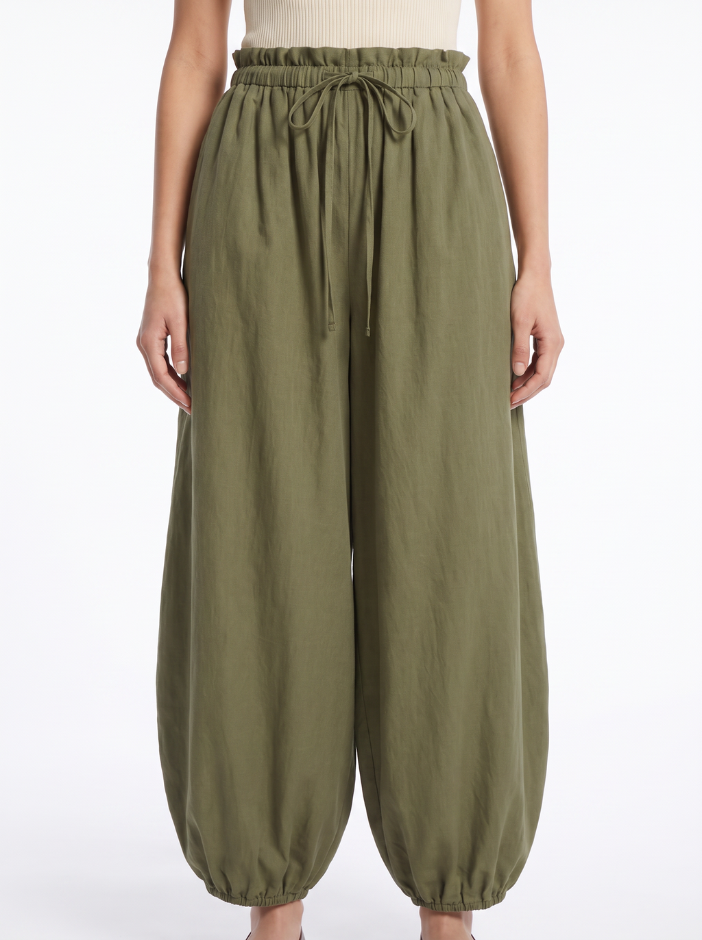 Close-up of the gathered high waistband and tapered leg