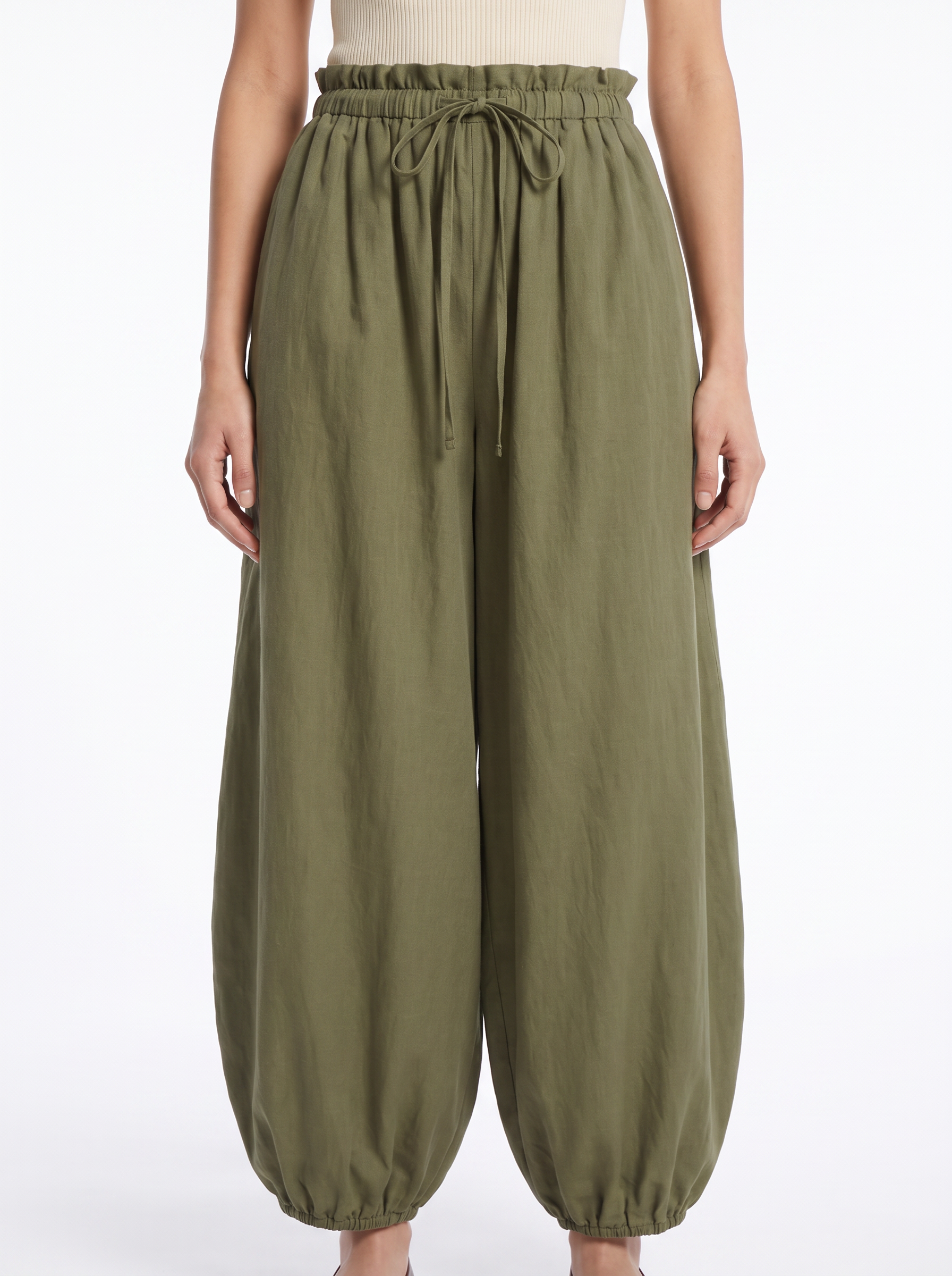 Close-up of the gathered high waistband and tapered leg