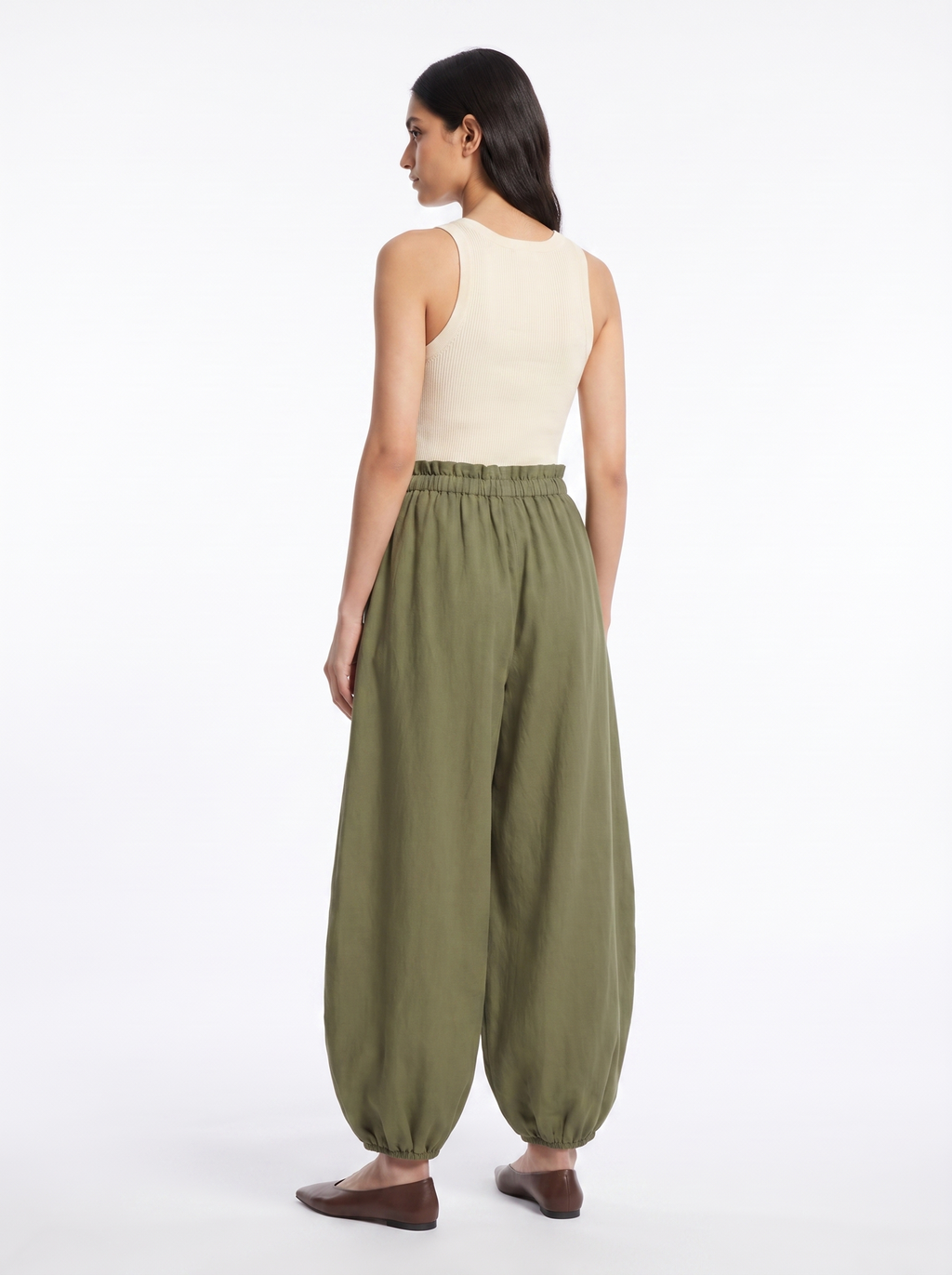 Balloon pants seen from a rear three-quarter angle