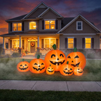 Connected inflatable pumpkins lit up in front of a house