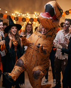 Person in a T-Rex costume at a Halloween party