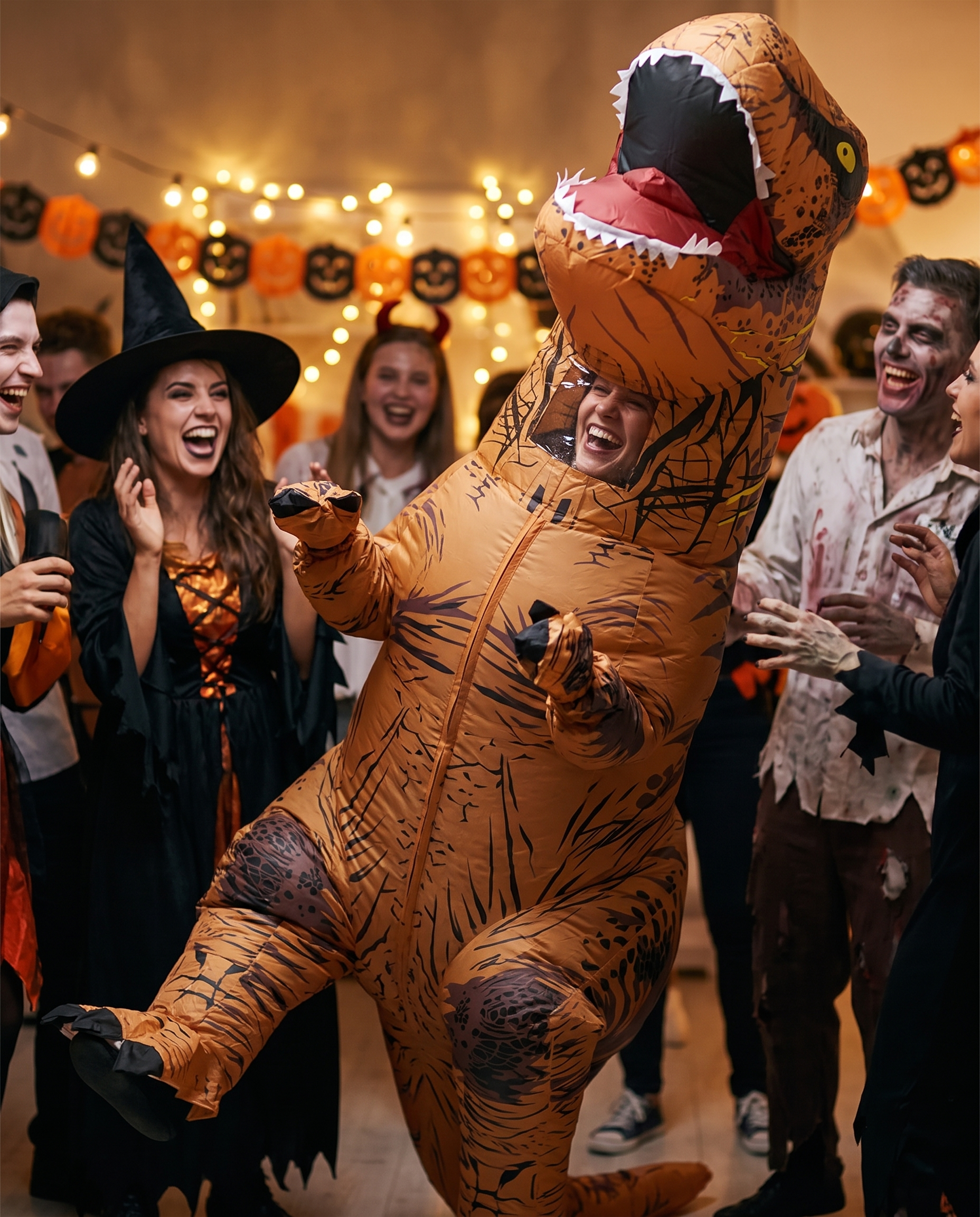 Person in a T-Rex costume at a Halloween party